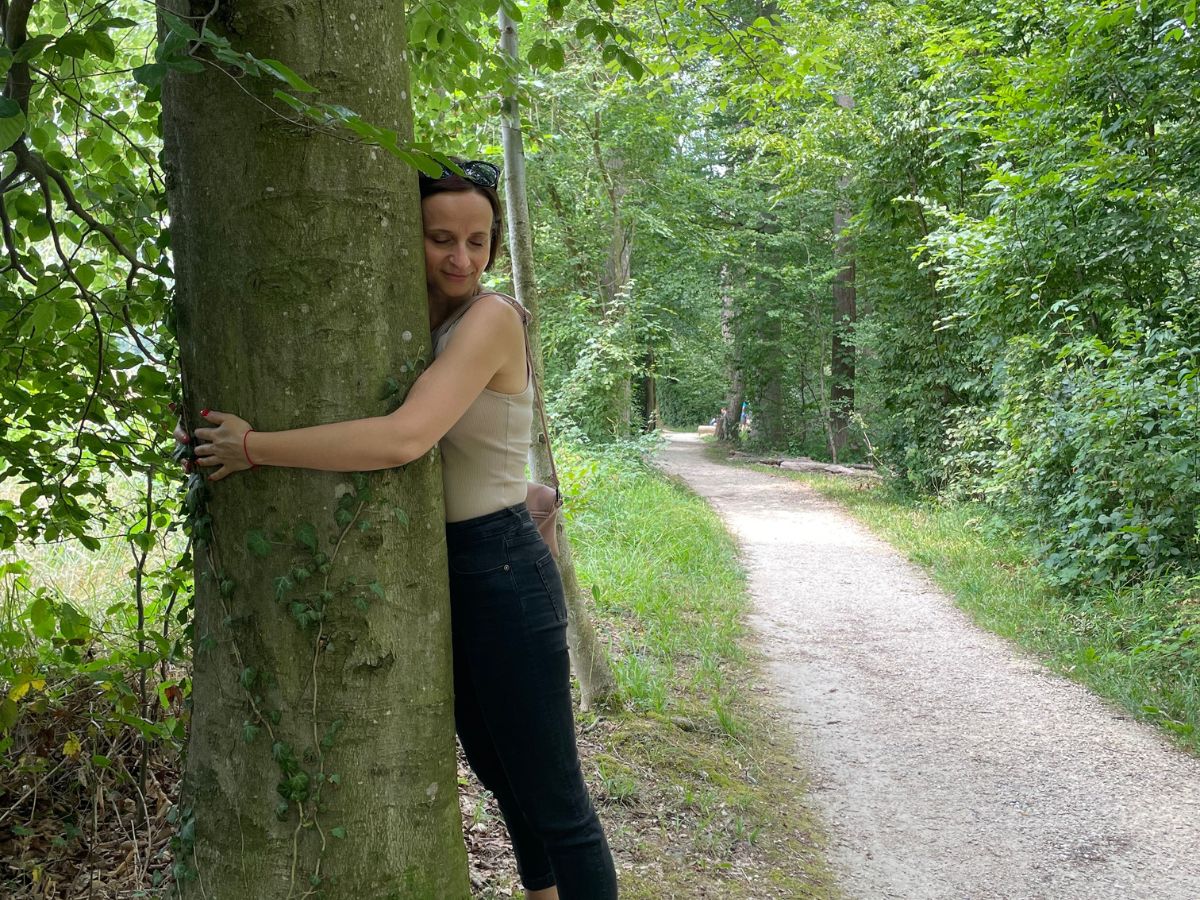 A woman hugs a tree