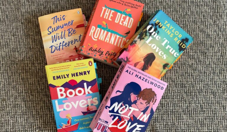 five books are beautifully assembled on the floor. They are all romance novels. The titles read (from right to left): 1. This Summer will be different 2. The Dead Romantics 3. One True Loves 4. Book Lovers 5. Not In Love